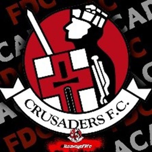 Crusaders FC football club crest: red shield with a white sword and cross and a white banner reading 'CRUSADERS F.C.'